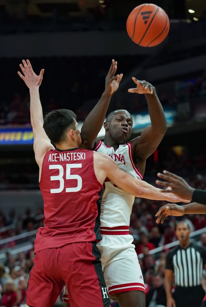Indiana Hoosiers forward Payton Sparks (24) passes the ball around Harvard Crimson forward Luca Ace-Nasteski (35) during the game against Harvard in Gainbridge Fieldhouse.